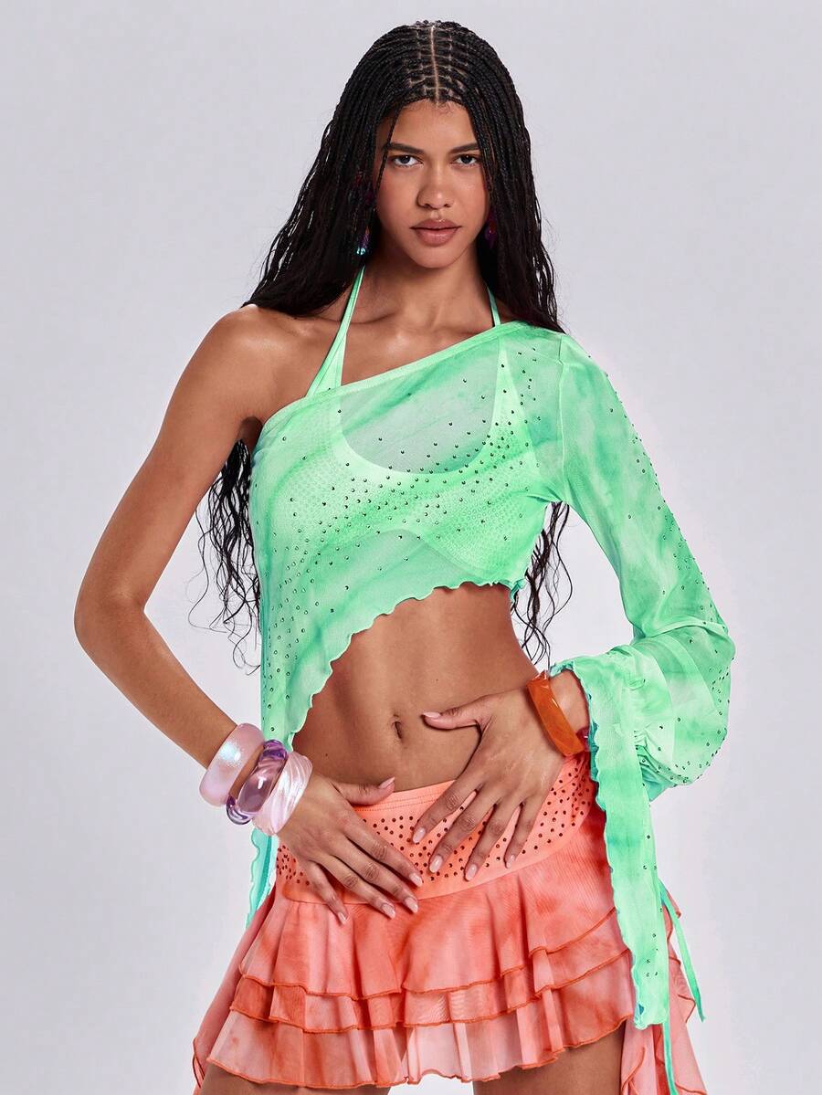 Women's one shoulder crop top featuring an asymmetrical long sleeve, colorful print, and sparkling rhinestone embellishments.