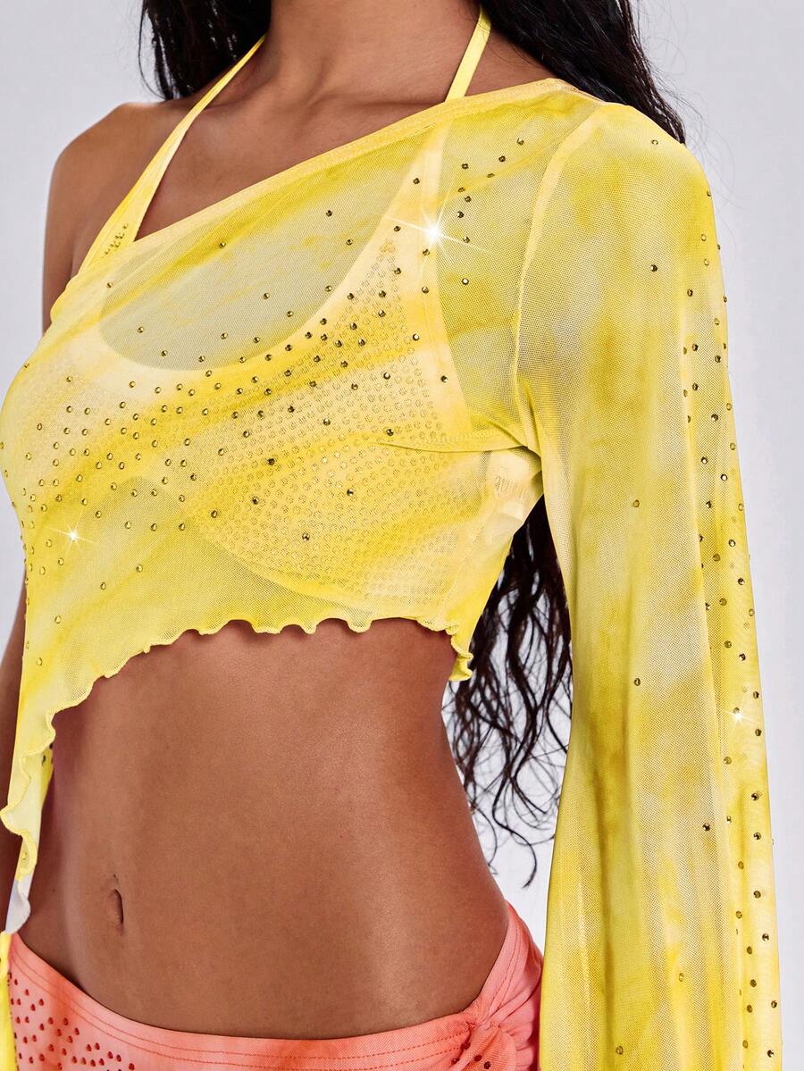 Women's one shoulder crop top featuring an asymmetrical long sleeve, colorful print, and sparkling rhinestone embellishments.