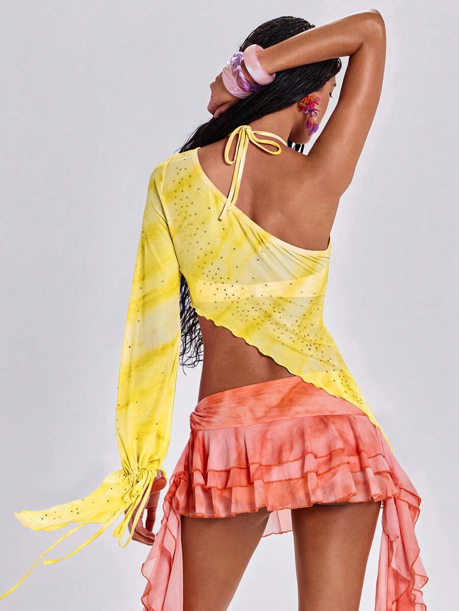 Women's one shoulder crop top featuring an asymmetrical long sleeve, colorful print, and sparkling rhinestone embellishments.