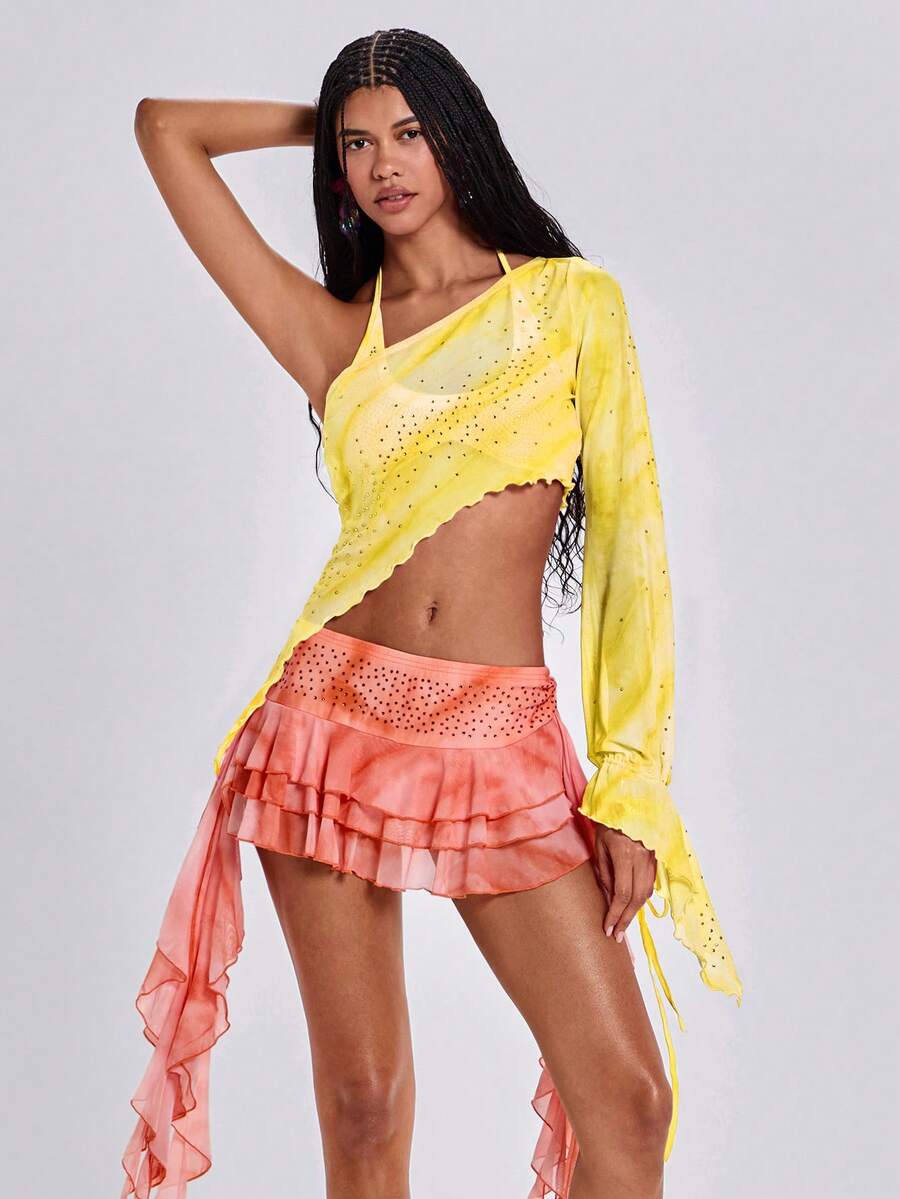 Women's one shoulder crop top featuring an asymmetrical long sleeve, colorful print, and sparkling rhinestone embellishments.