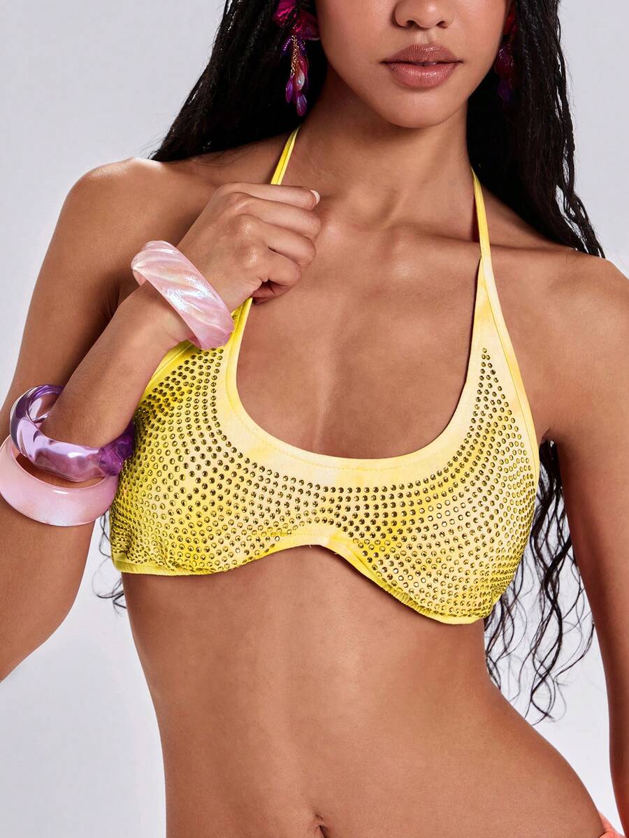 Women's one shoulder crop top featuring an asymmetrical long sleeve, colorful print, and sparkling rhinestone embellishments.