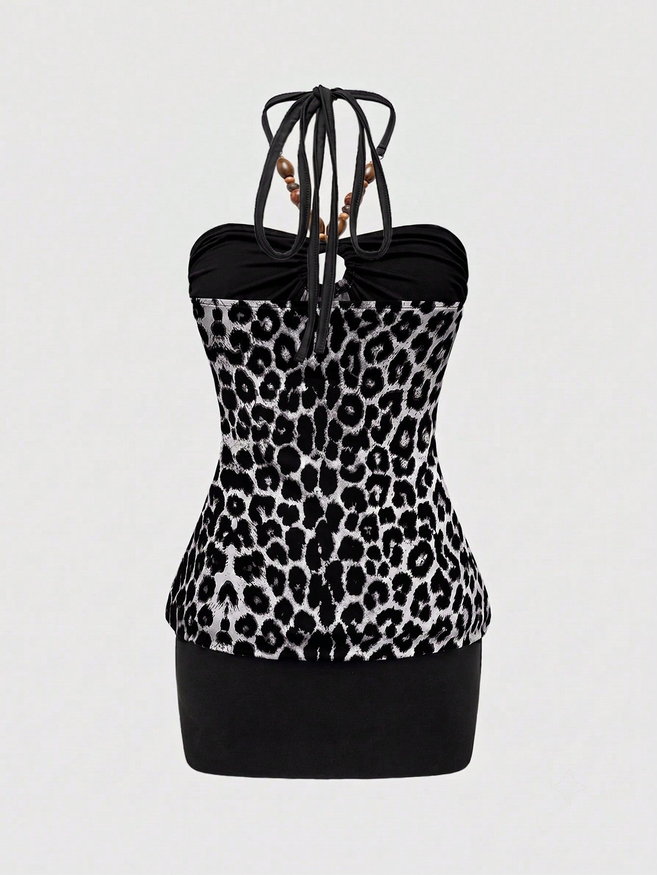 Women's Y2K halter neck leopard print bodycon mini dress with beaded decor, patchwork design, backless knot detail, slim fit, and sleeveless mini length.
