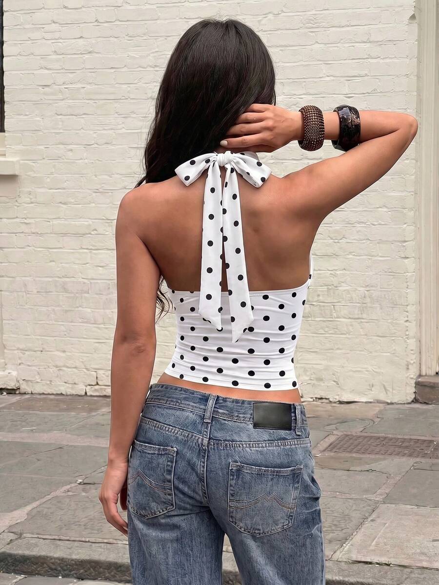 Women's backless halter top featuring a knot detail, slim fit silhouette, and long length knitted fabric.