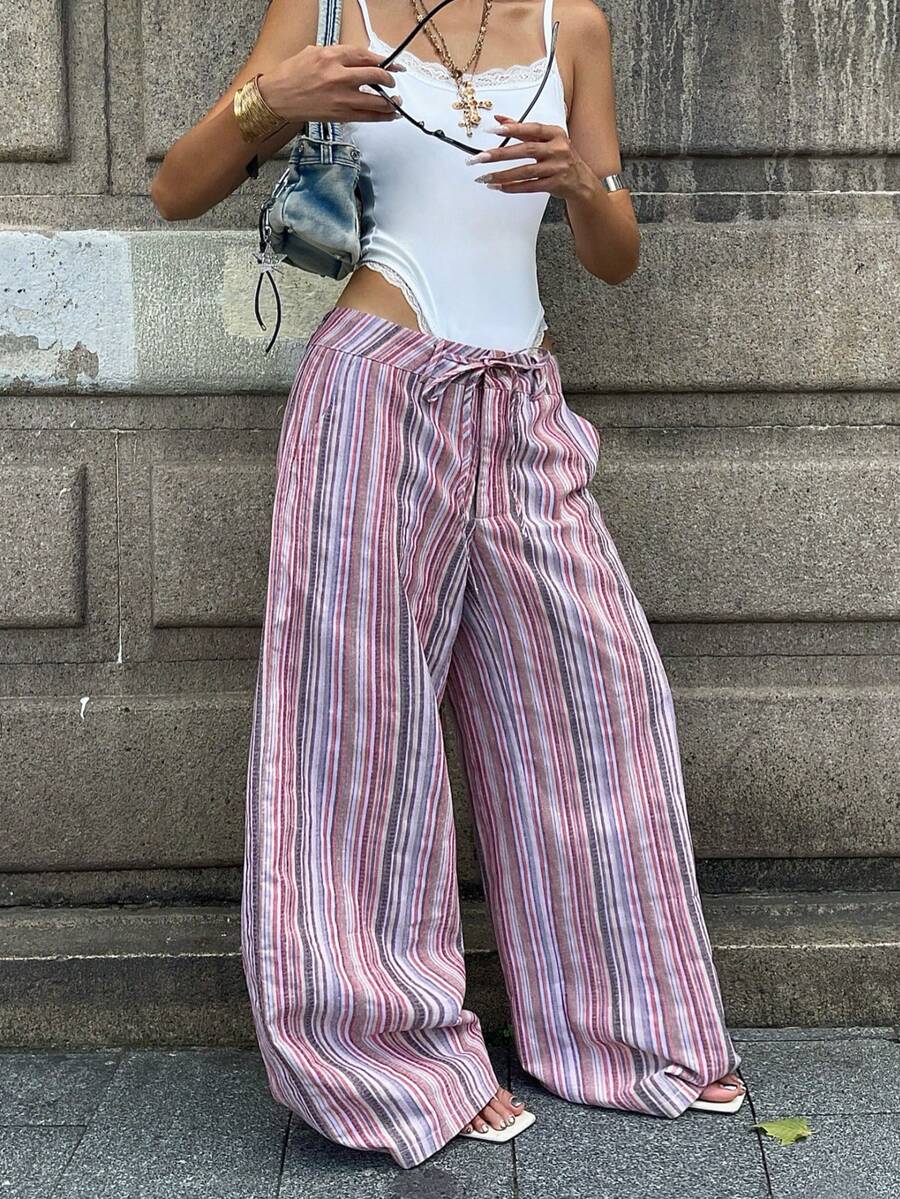 Women's casual straight leg striped woven pants featuring a low waist and zipper fly closure.