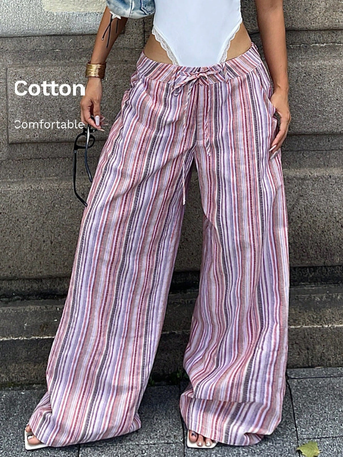 Women's casual straight leg striped woven pants featuring a low waist and zipper fly closure.
