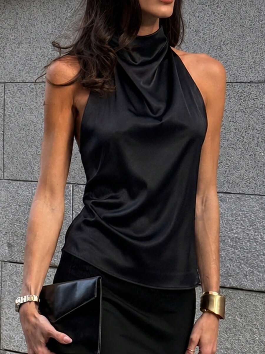 Women's black sleeveless halter top featuring a backless design and plain knitted fabric.