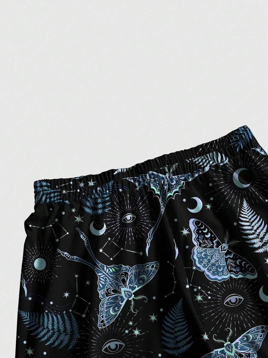 Women's plus size black gothic wide leg pants with split thigh detail and celestial moth, sun, and star pattern.