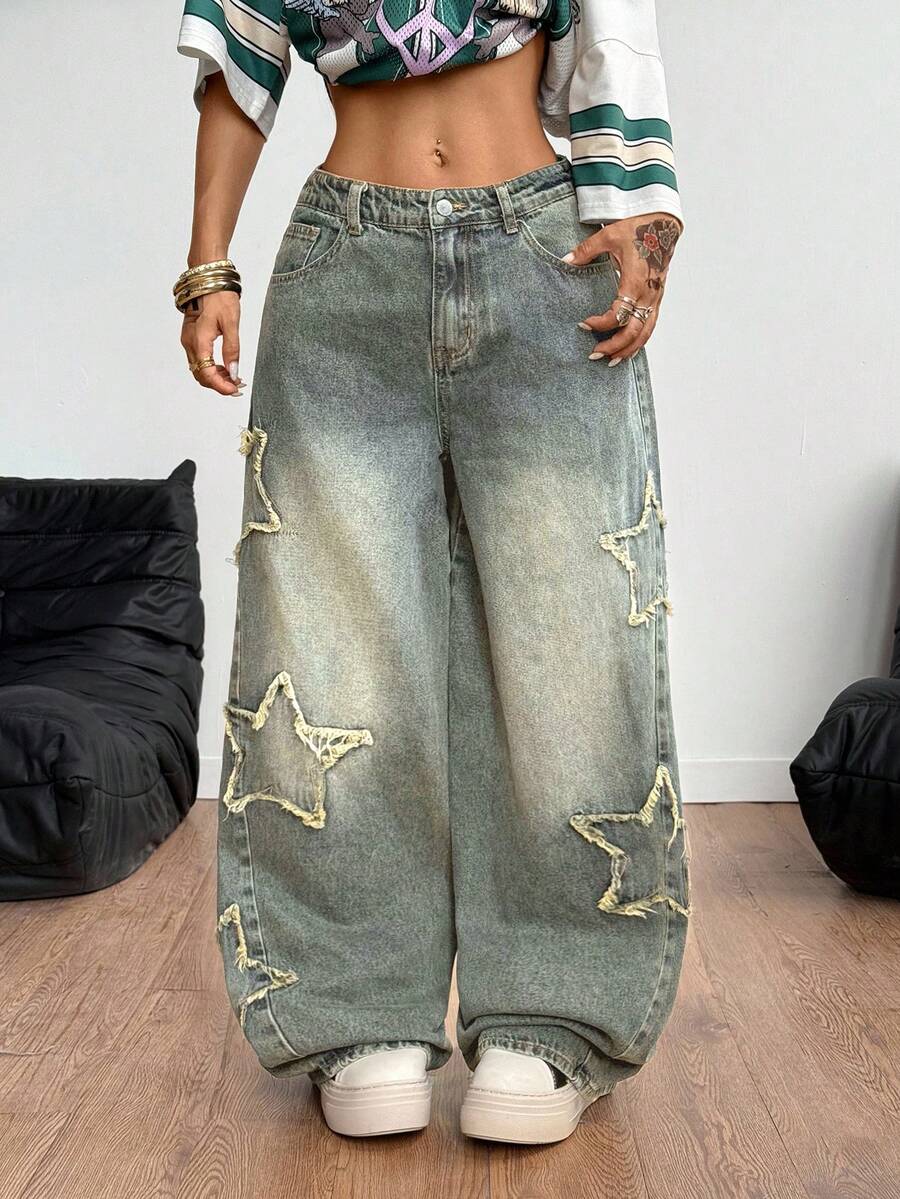 Women's loose fit baggy jeans in washed denim featuring star patches, slant pockets, and a mid-rise cut.