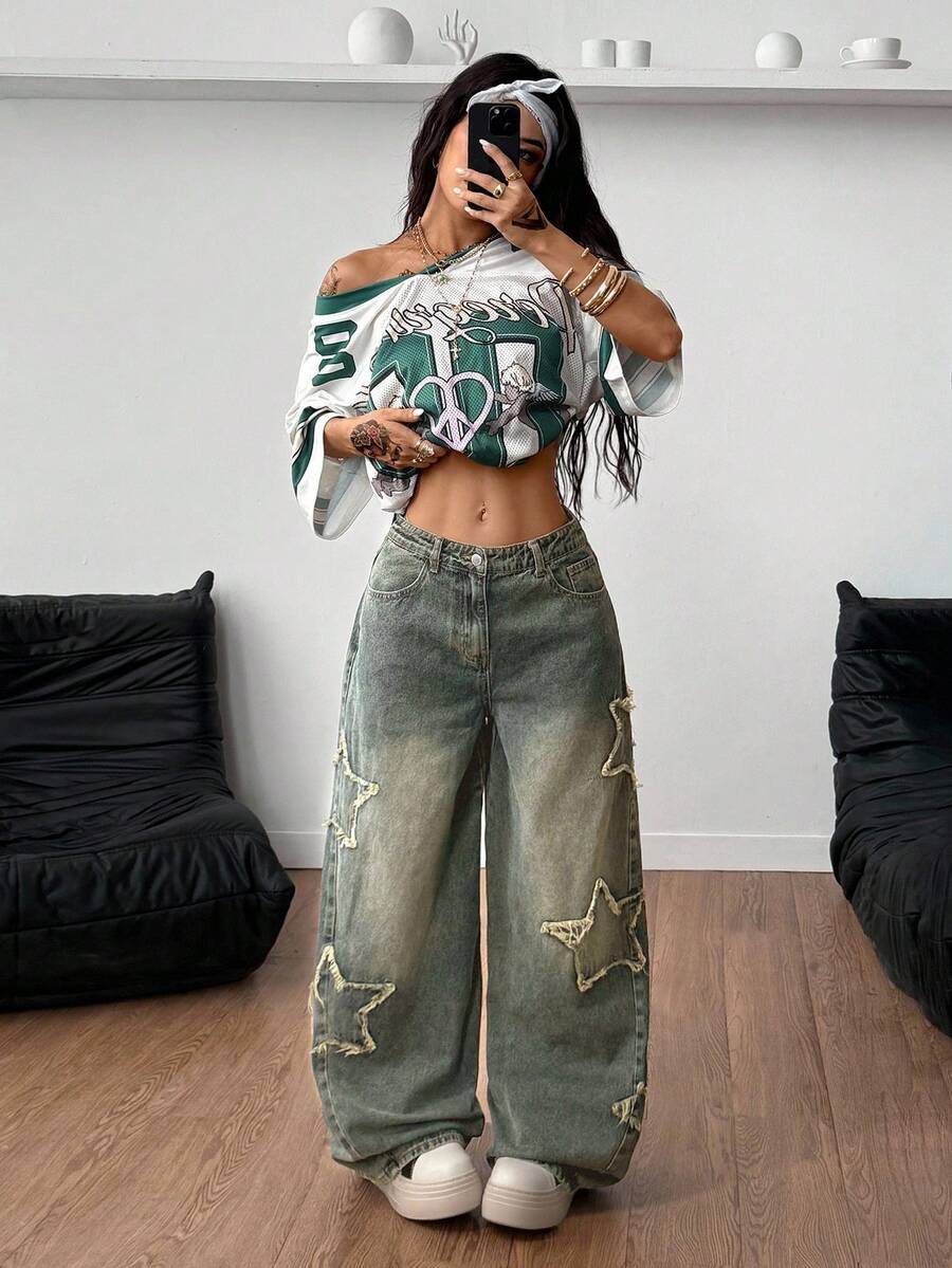 Women's loose fit baggy jeans in washed denim featuring star patches, slant pockets, and a mid-rise cut.