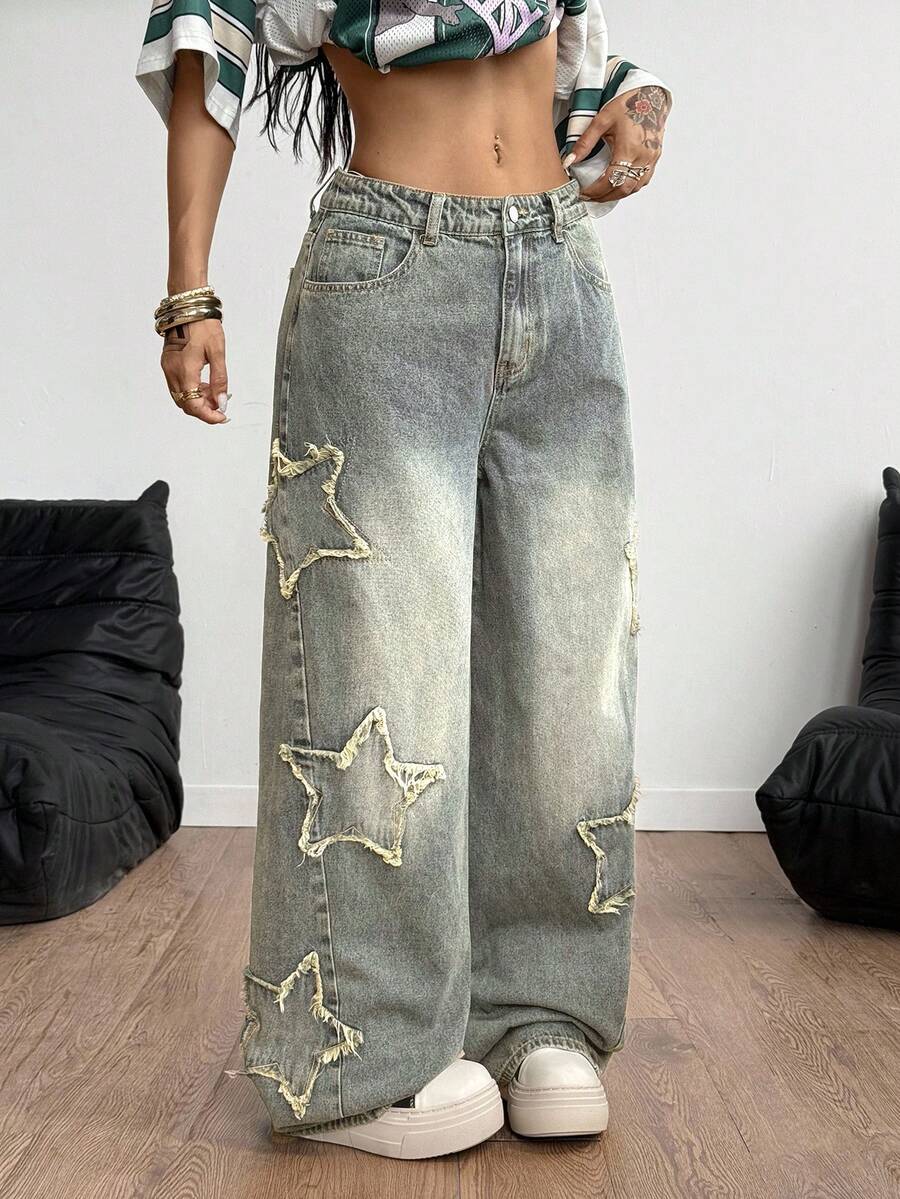 Women's loose fit baggy jeans in washed denim featuring star patches, slant pockets, and a mid-rise cut.