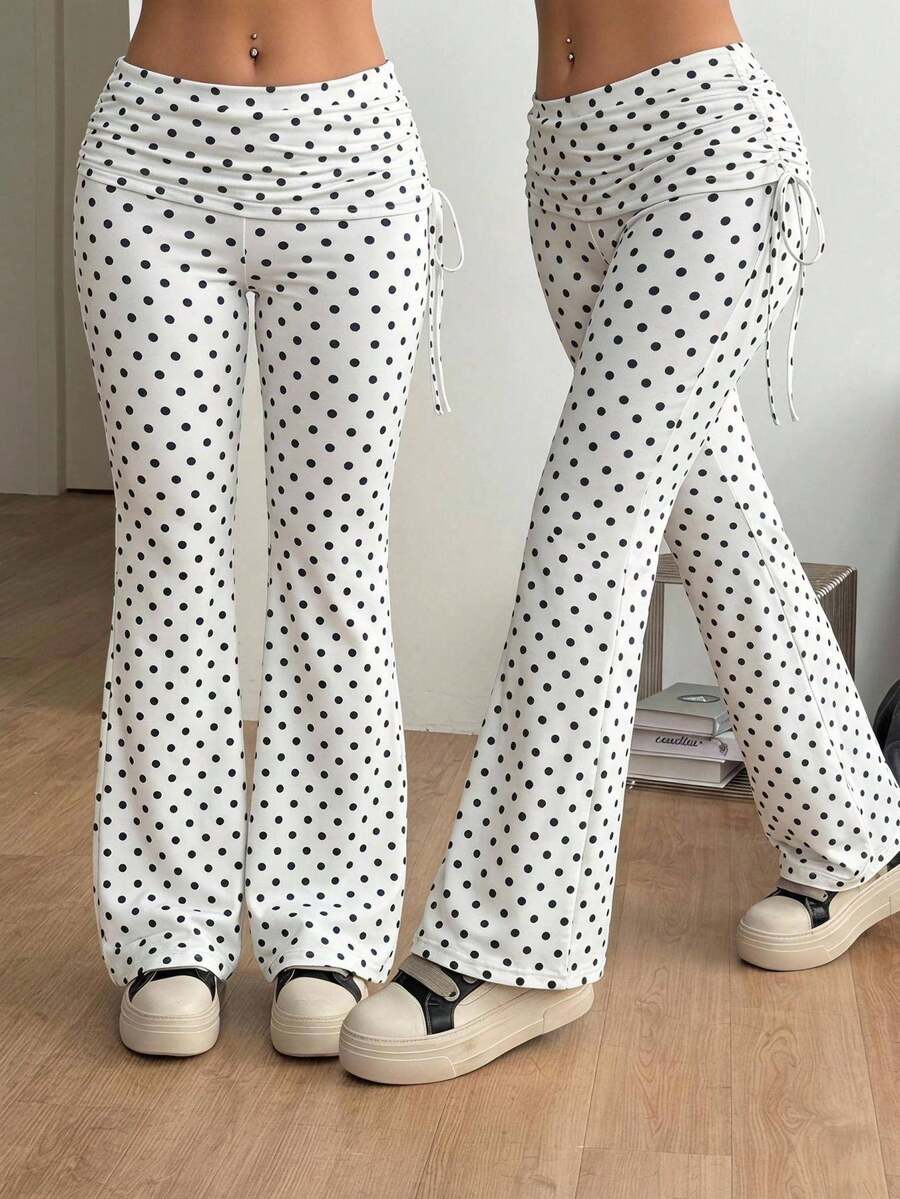 Women's striped flare leg pants featuring a mid-rise waist, slim fit thigh, and ruched side drawstring detail in stretch knit fabric.