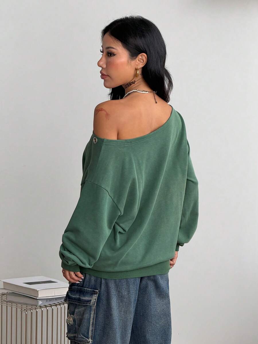Women's sage green asymmetrical shoulder sweatshirt with button eyelet detail, drop shoulder long sleeves, and a loose casual fit.