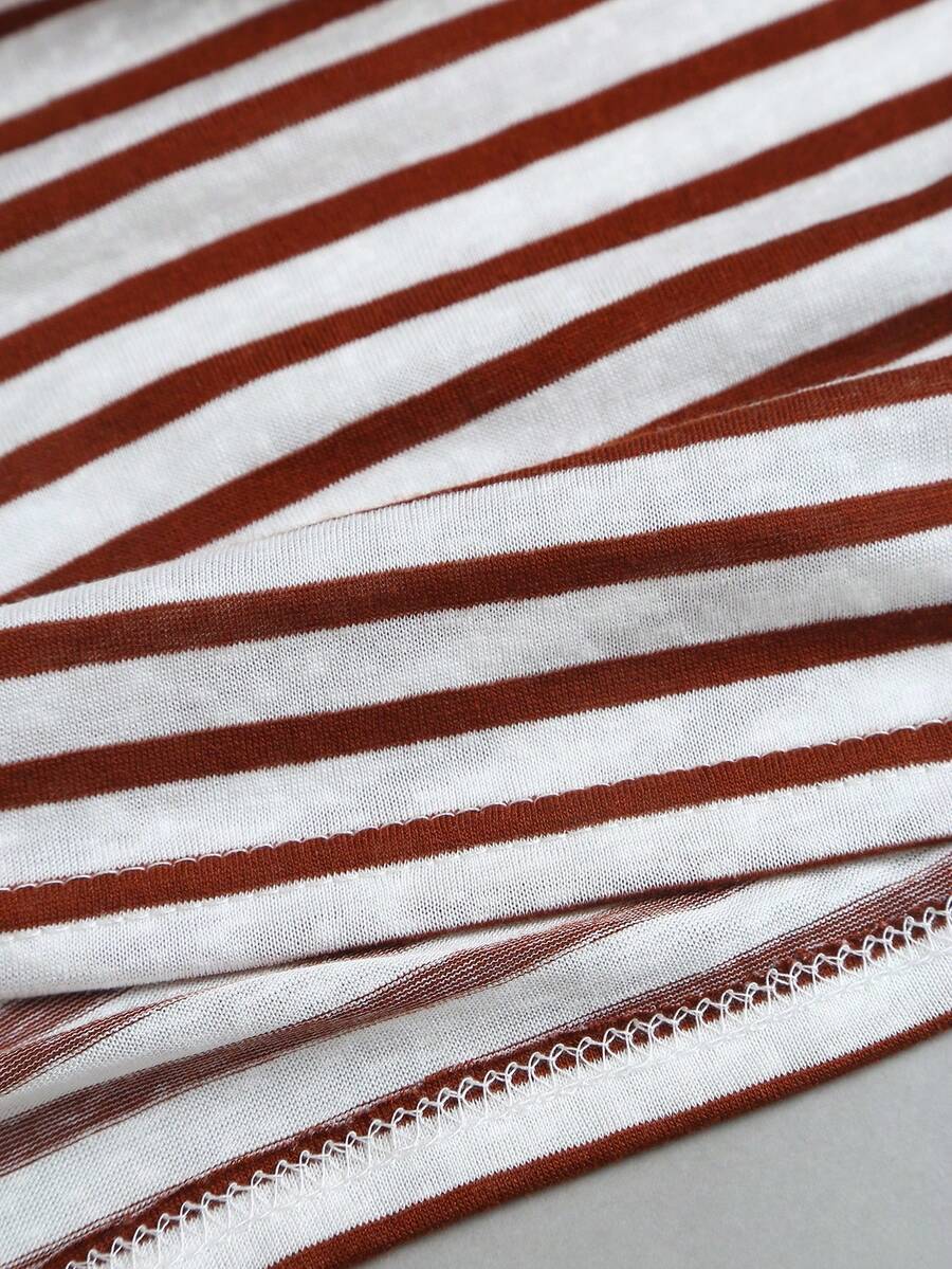 Women's striped tank top featuring an asymmetrical cold shoulder neckline and semi-sheer back.