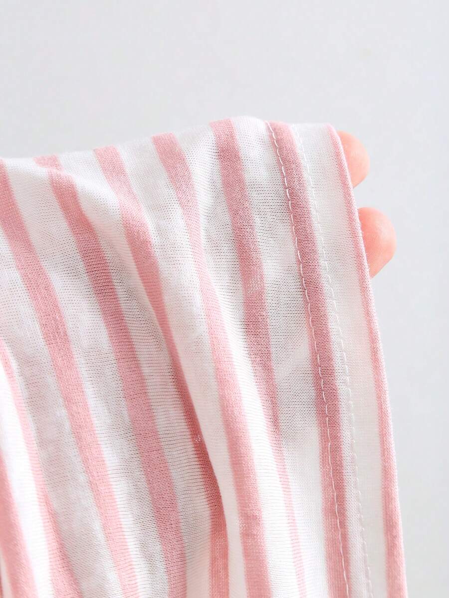 Women's striped tank top featuring an asymmetrical cold shoulder neckline and semi-sheer back.