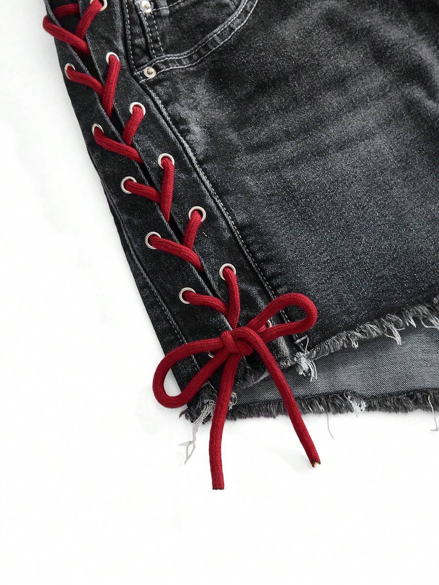 Plus size black gothic mini shorts with heart embroidery, graphic pocket pattern, lace-up detail, raw hem, and zipper fly