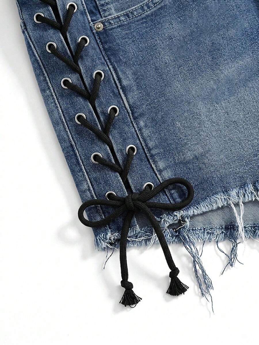 Plus size black gothic mini shorts with heart embroidery, graphic pocket pattern, lace-up detail, raw hem, and zipper fly