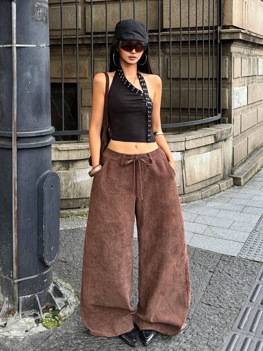 Women's casual straight leg striped woven pants featuring a low waist and zipper fly closure.