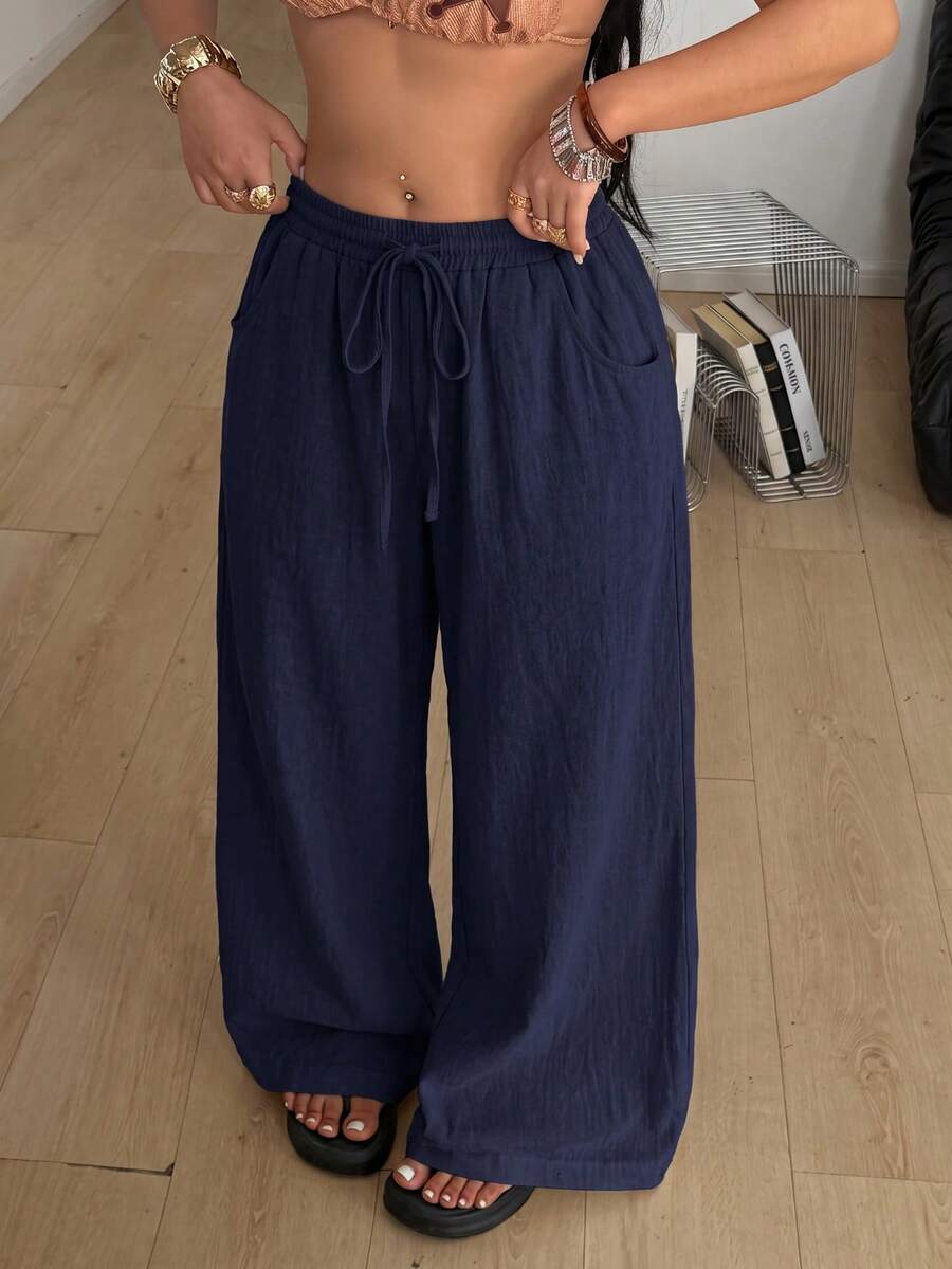 Plus size women's striped loose straight leg cropped pants with pleated detailing and side pockets