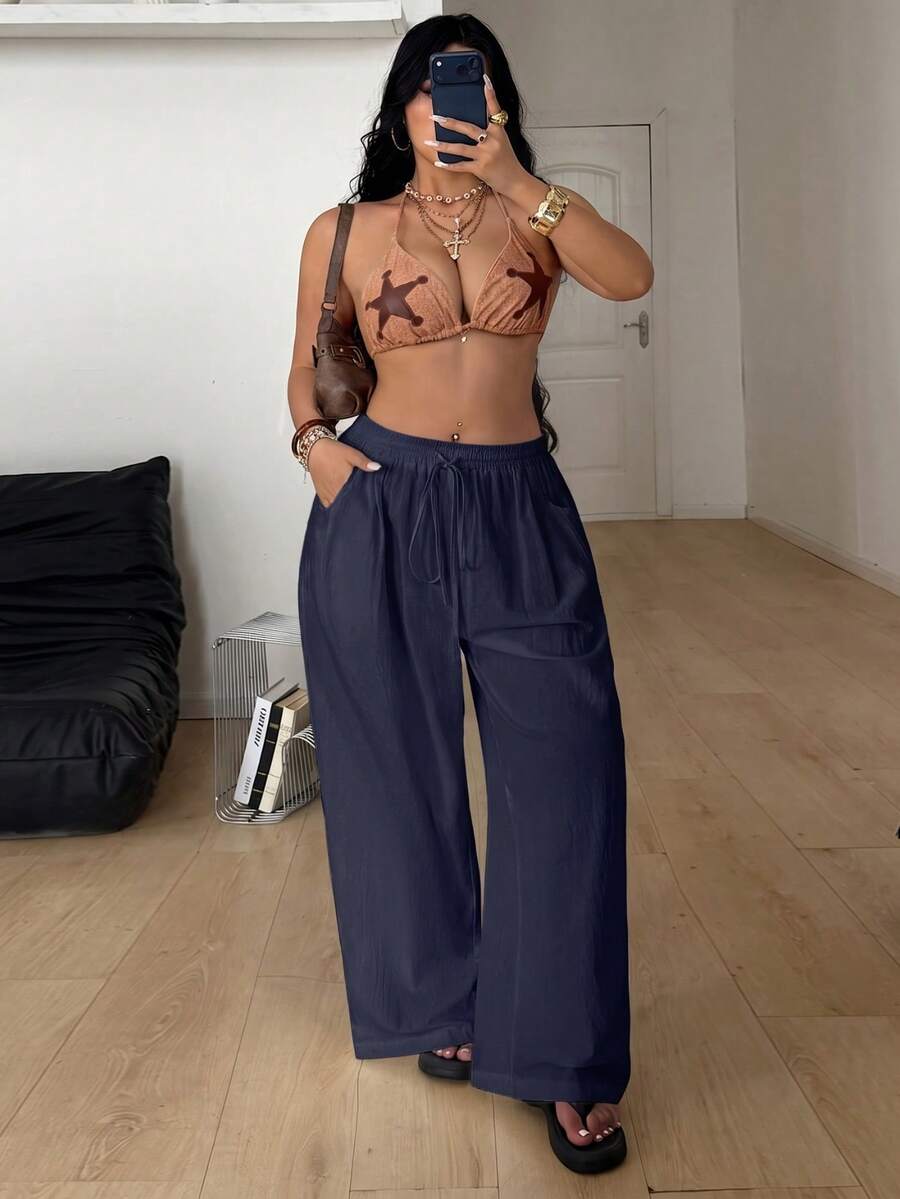 Plus size women's striped loose straight leg cropped pants with pleated detailing and side pockets