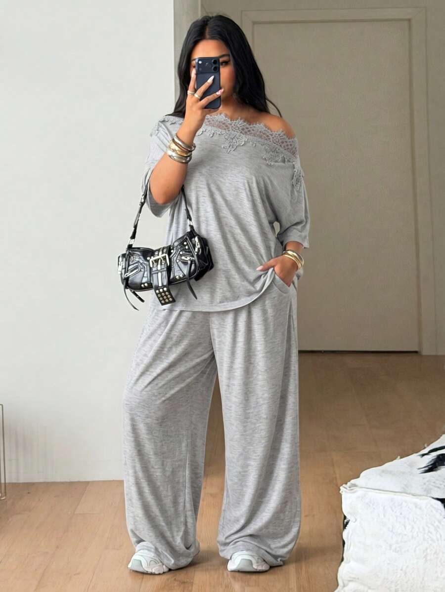 Women's casual two-piece outfit featuring a loose short-sleeve asymmetrical neck t-shirt and matching long wide leg pants with pockets.