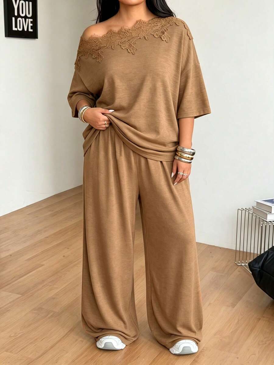 Women's casual two-piece outfit featuring a loose short-sleeve asymmetrical neck t-shirt and matching long wide leg pants with pockets.