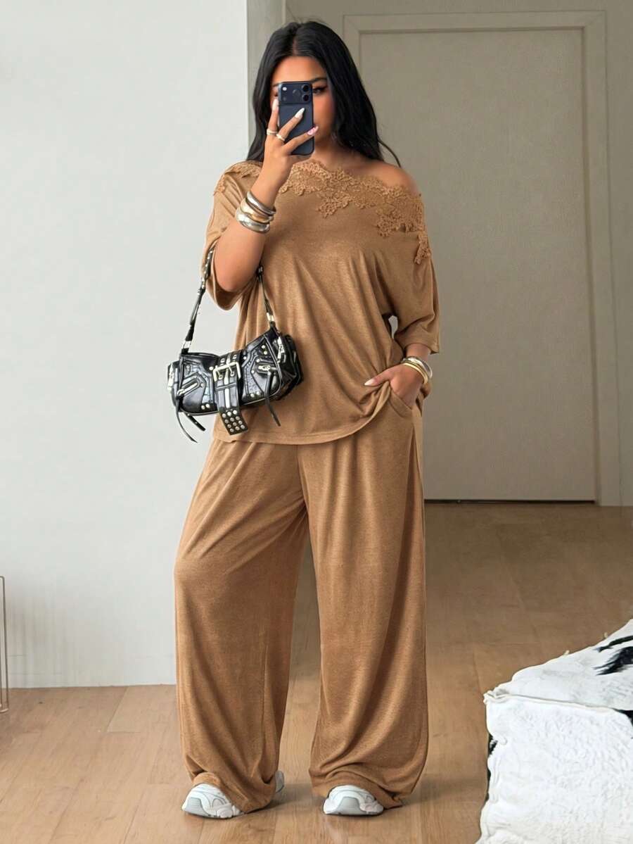 Women's casual two-piece outfit featuring a loose short-sleeve asymmetrical neck t-shirt and matching long wide leg pants with pockets.