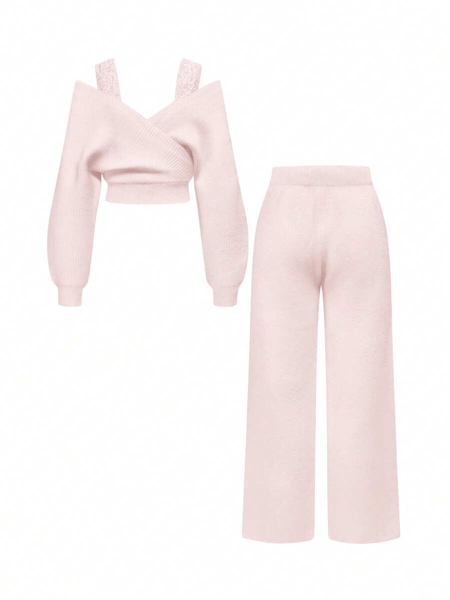Women's two-piece rib-knit sweater set featuring a long-sleeve cold-shoulder crop top with strap details and matching wide-leg pants.