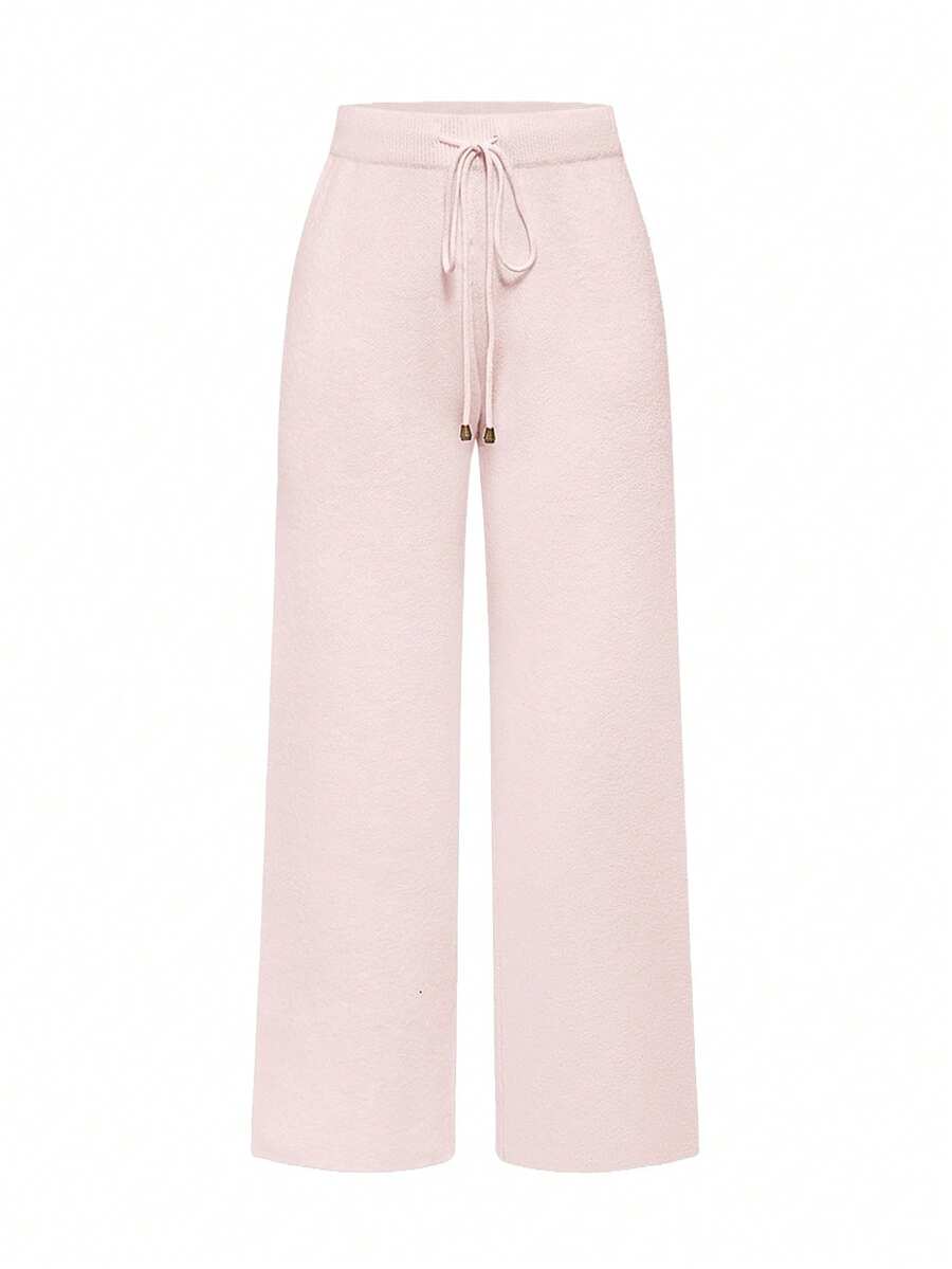 Women's two-piece rib-knit sweater set featuring a long-sleeve cold-shoulder crop top with strap details and matching wide-leg pants.