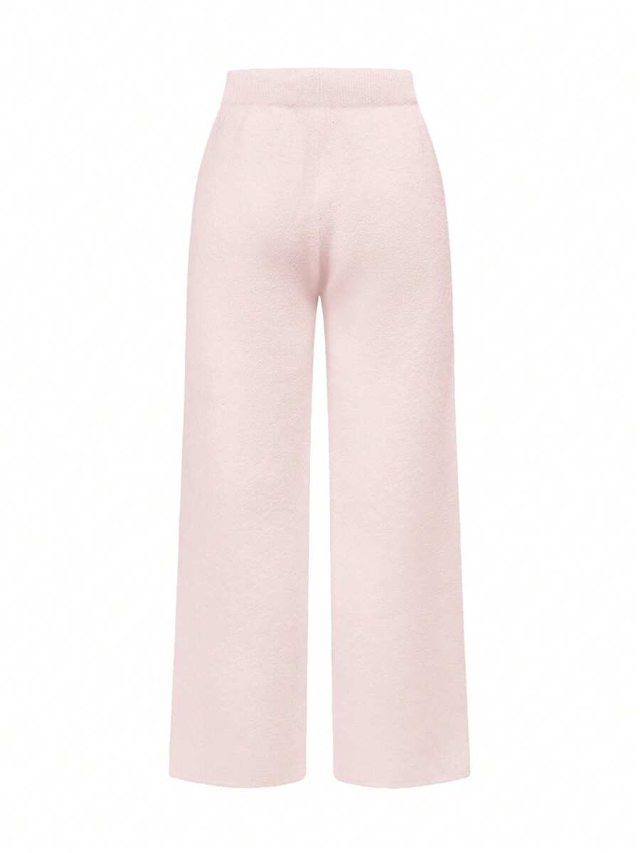 Women's two-piece rib-knit sweater set featuring a long-sleeve cold-shoulder crop top with strap details and matching wide-leg pants.