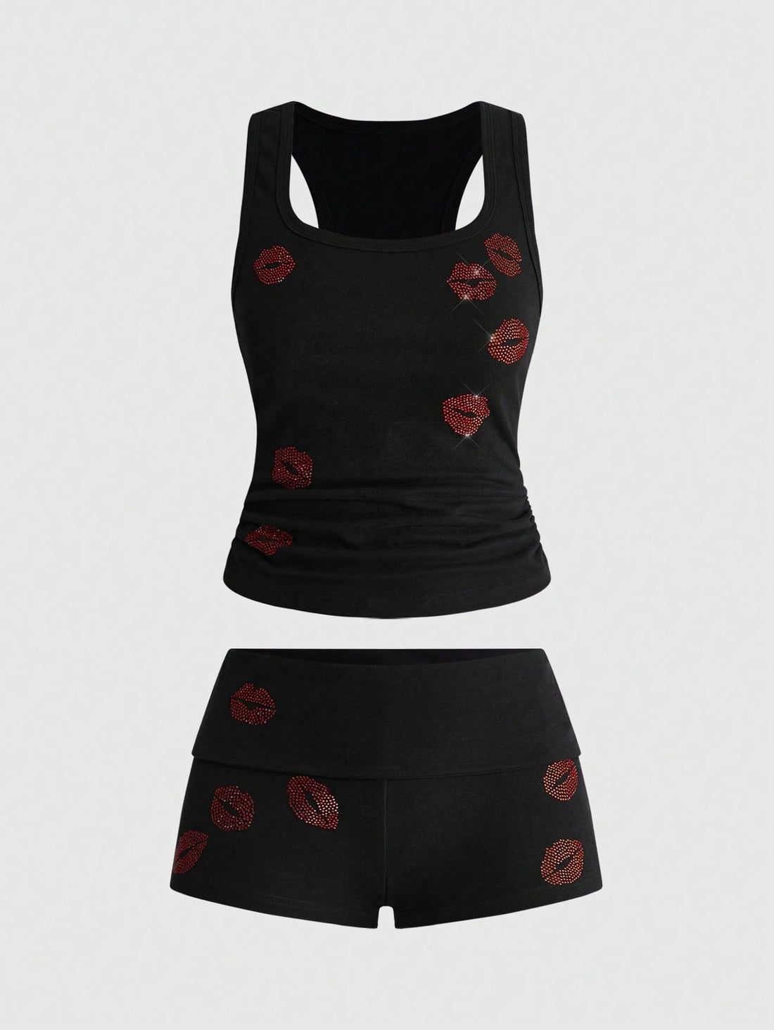 Punk-inspired two-piece set with a fitted scoop neck slogan tank top featuring cross and rhinestone details paired with ultra low waist mini shorts.