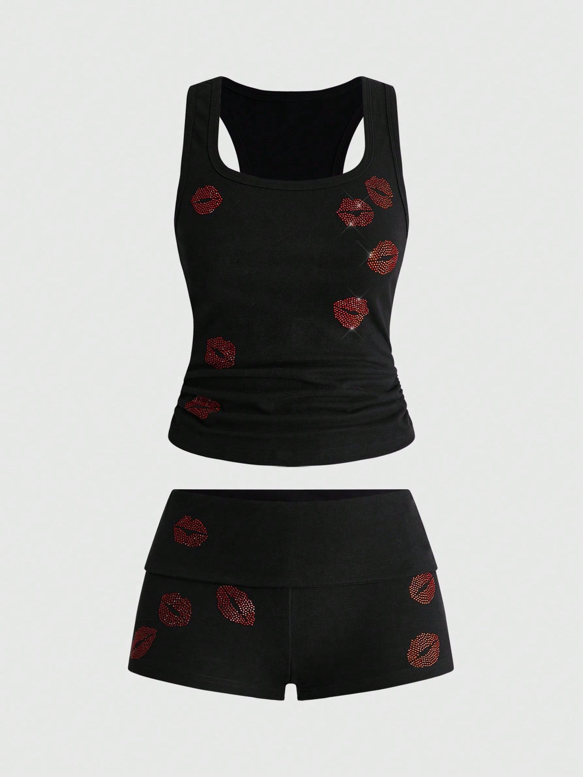 Punk-inspired two-piece set with a fitted scoop neck slogan tank top featuring cross and rhinestone details paired with ultra low waist mini shorts.