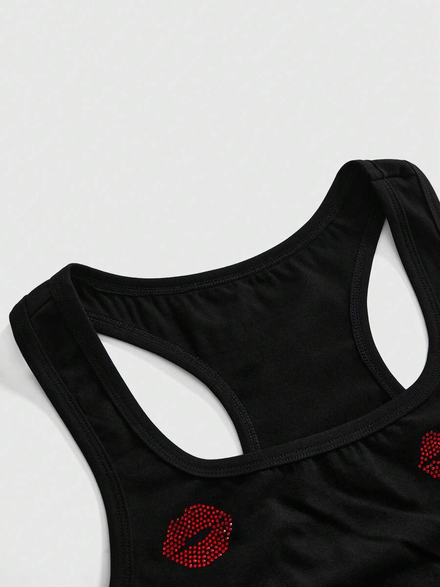 Punk-inspired two-piece set with a fitted scoop neck slogan tank top featuring cross and rhinestone details paired with ultra low waist mini shorts.
