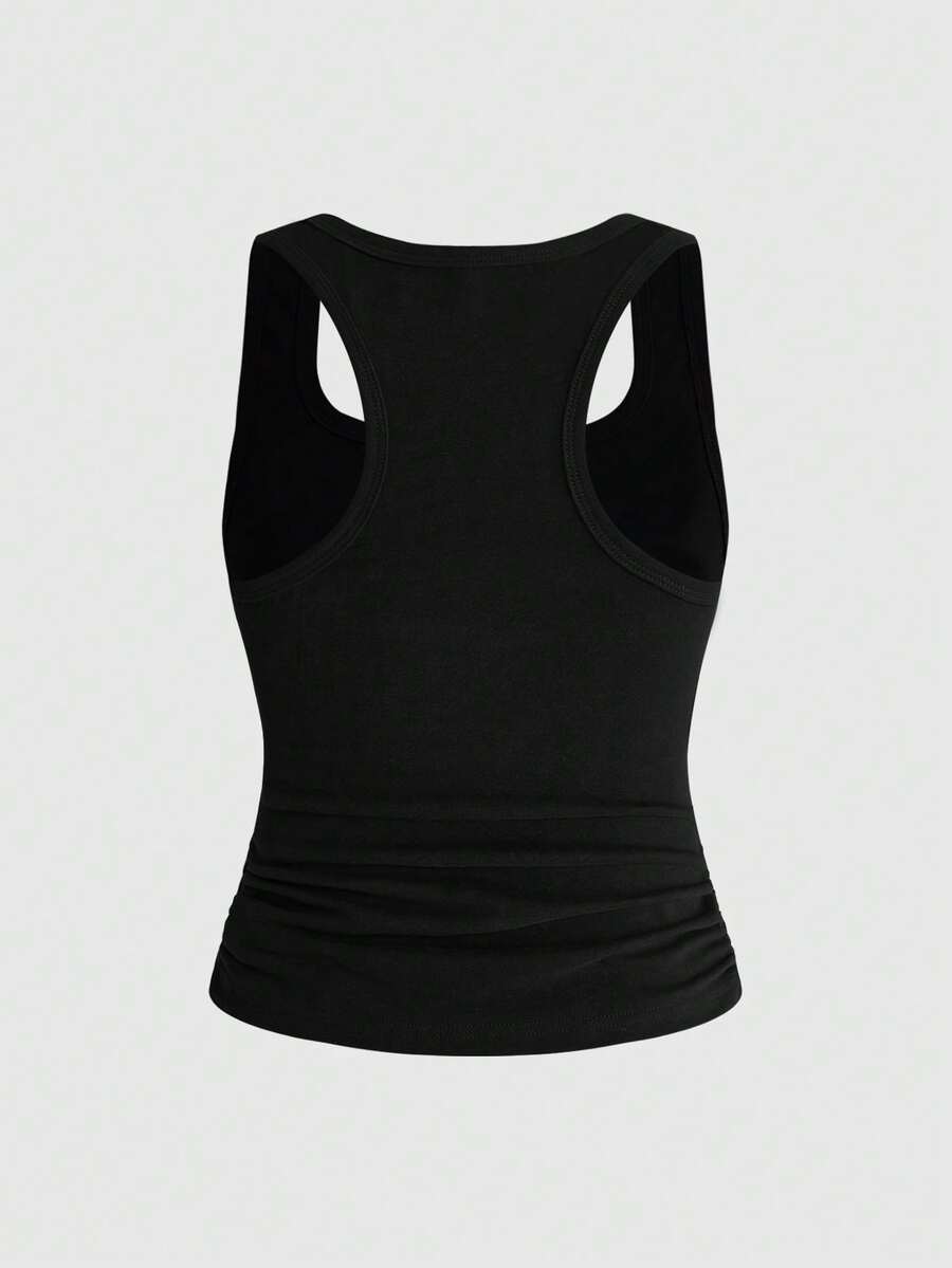 Punk-inspired two-piece set with a fitted scoop neck slogan tank top featuring cross and rhinestone details paired with ultra low waist mini shorts.