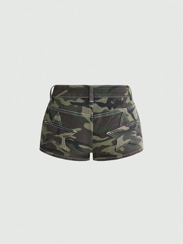 Women's ultra low waist mini shorts with back pockets, zipper fly, button detail, random print, and star patch in a grunge punk Y2K style.