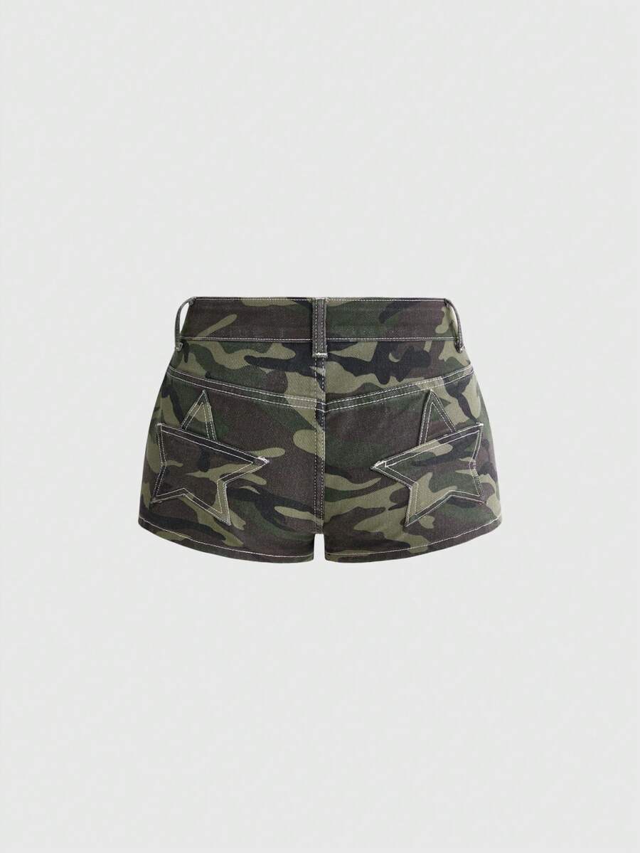 Women's ultra low waist mini shorts with back pockets, zipper fly, button detail, random print, and star patch in a grunge punk Y2K style.