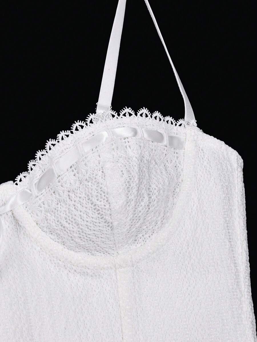White elegant corset top with lace trim, cup details, adjustable spaghetti straps, and a back tie with grommet eyelets.