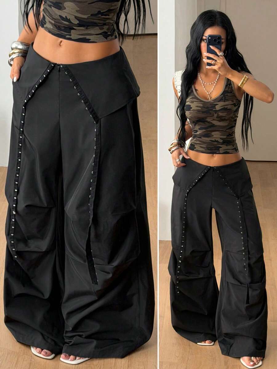 Women's low rise parachute cargo pants featuring a loose straight leg cut, functional pockets, zipper fly, and subtle studded accents.