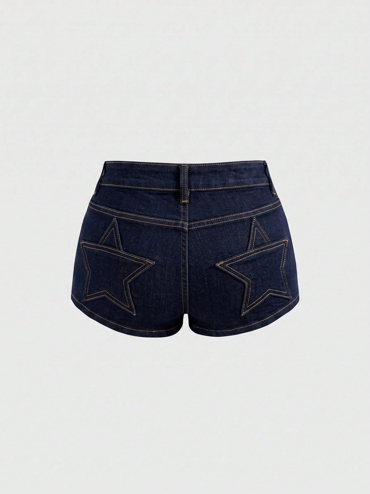 Women's ultra low waist mini shorts with back pockets, zipper fly, button detail, random print, and star patch in a grunge punk Y2K style.