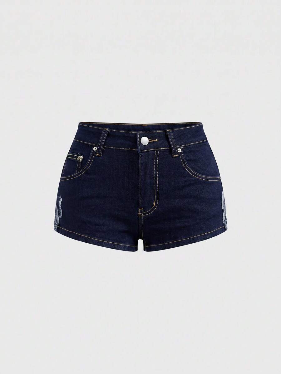 Women's ultra low waist mini shorts with back pockets, zipper fly, button detail, random print, and star patch in a grunge punk Y2K style.