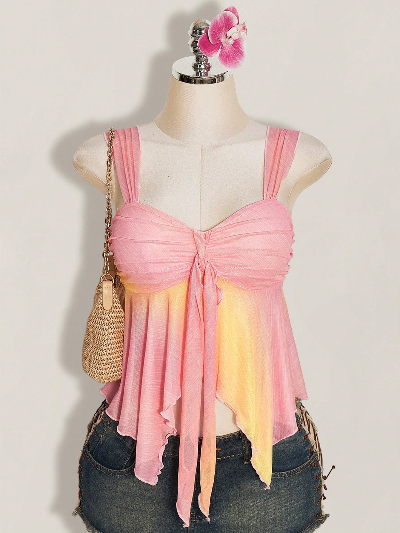 Women's pink semi-sheer mesh camisole with straps, slim fit, asymmetrical ruffle hem, drawstring, and knot details