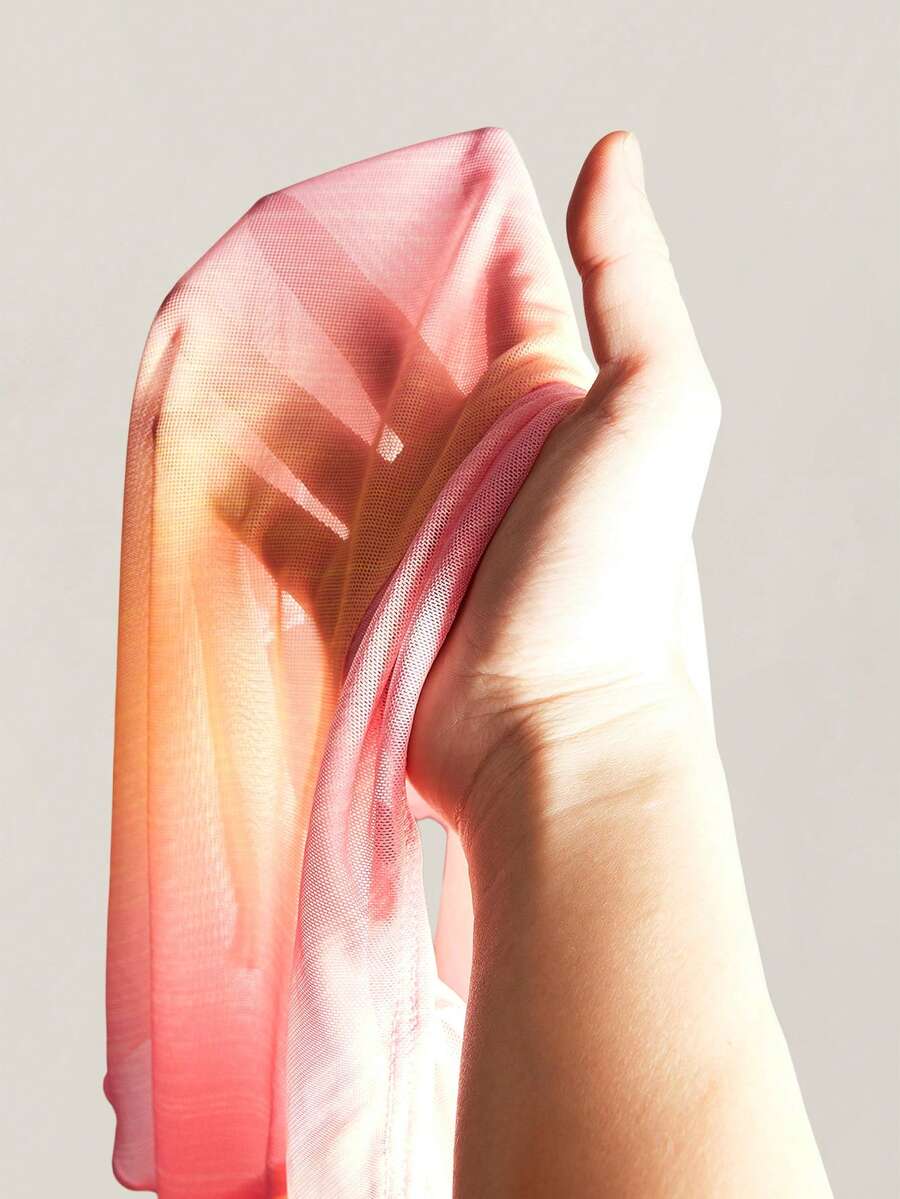 Women's pink semi-sheer mesh camisole with straps, slim fit, asymmetrical ruffle hem, drawstring, and knot details