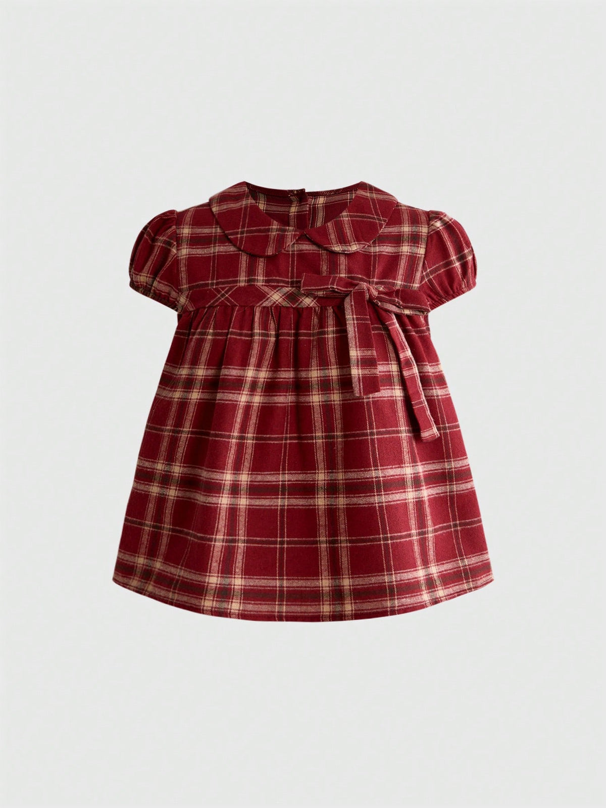 Short sleeve plaid shirt for women featuring a Peter Pan collar with a bow accent, puff sleeves, and a flared hem.