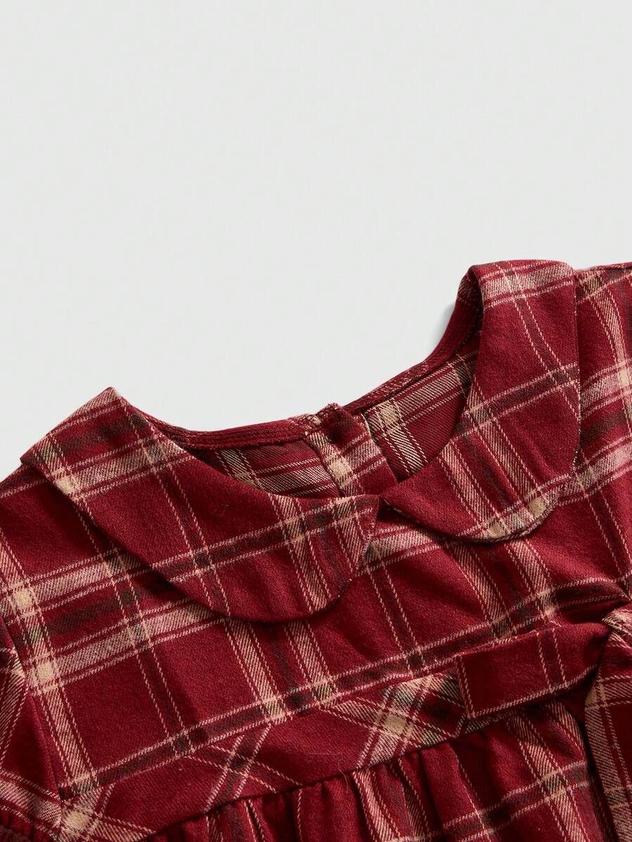 Short sleeve plaid shirt for women featuring a Peter Pan collar with a bow accent, puff sleeves, and a flared hem.