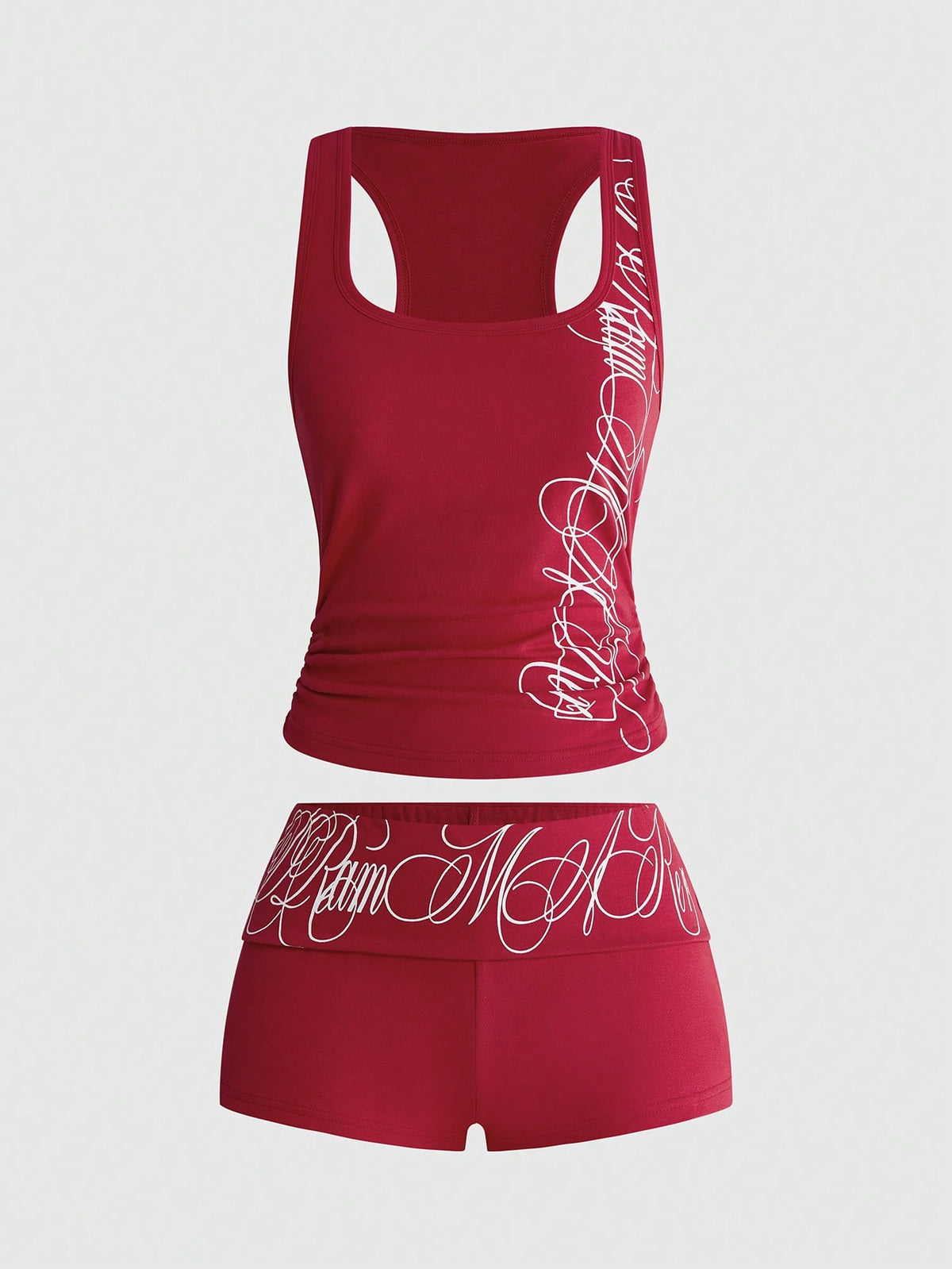 Punk-inspired two-piece set with a fitted scoop neck slogan tank top featuring cross and rhinestone details paired with ultra low waist mini shorts.