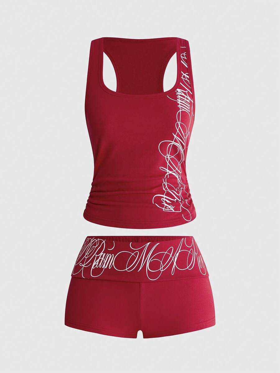 Punk-inspired two-piece set with a fitted scoop neck slogan tank top featuring cross and rhinestone details paired with ultra low waist mini shorts.