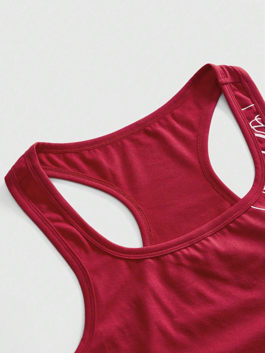 Punk-inspired two-piece set with a fitted scoop neck slogan tank top featuring cross and rhinestone details paired with ultra low waist mini shorts.