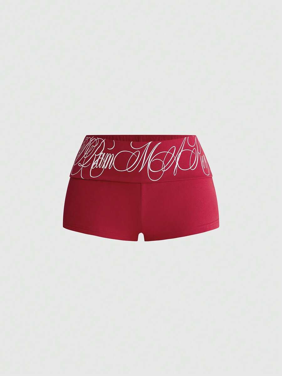 Punk-inspired two-piece set with a fitted scoop neck slogan tank top featuring cross and rhinestone details paired with ultra low waist mini shorts.