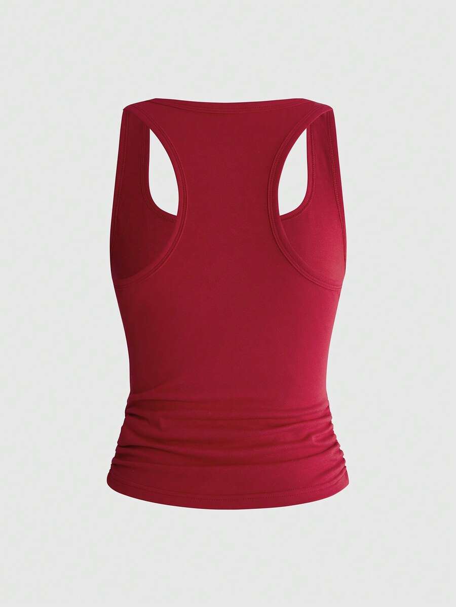 Punk-inspired two-piece set with a fitted scoop neck slogan tank top featuring cross and rhinestone details paired with ultra low waist mini shorts.