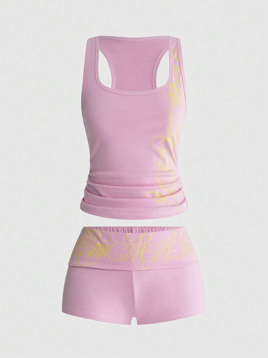 Punk-inspired two-piece set with a fitted scoop neck slogan tank top featuring cross and rhinestone details paired with ultra low waist mini shorts.