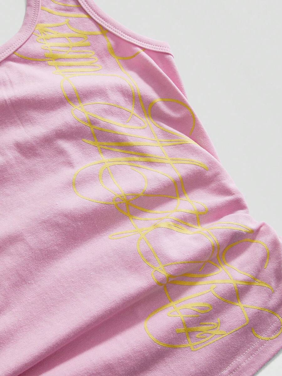 Punk-inspired two-piece set with a fitted scoop neck slogan tank top featuring cross and rhinestone details paired with ultra low waist mini shorts.